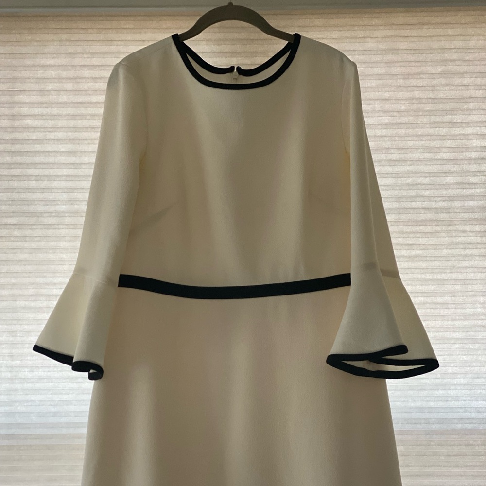 Beautiful, versatile off white with black trim dress and bell sleeves.